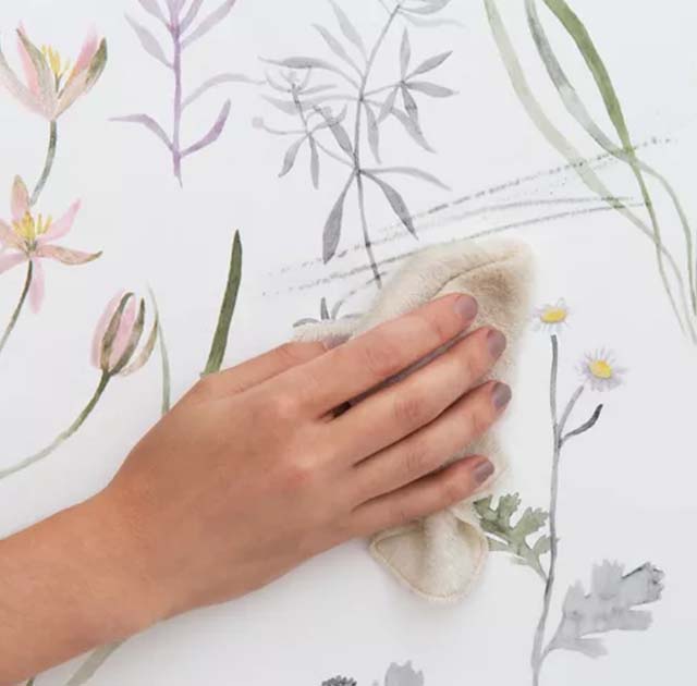 a-hand-wipes-floral-wallpaper-emphasizing-cleanliness-and-maintenance-in-line-with-blue-wallpaper-trends-for-interiors A hand wipes floral wallpaper, emphasizing cleanliness and maintenance in line with blue wallpaper trends for interiors.