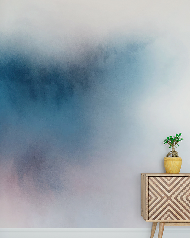 A minimalist room featuring a gradient blue wallpaper, highlighting blue wallpaper trends, with a wooden cabinet and small plant