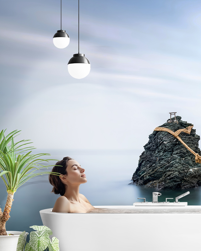 a-woman-relaxing-in-a-bathtub-with-scenic-ocean-themed-wallpaper-and-pendant-lighting A woman relaxing in a bathtub with scenic ocean-themed wallpaper and pendant lighting