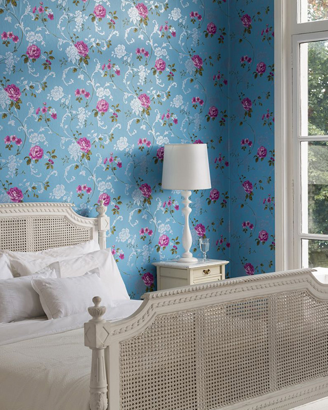 bedroom-with-floral-blue-wallpaper-and-lighting-featuring-a-white-bedside-lamp-and-elegant-white-furniture Bedroom with floral blue wallpaper and lighting featuring a white bedside lamp and elegant white furniture