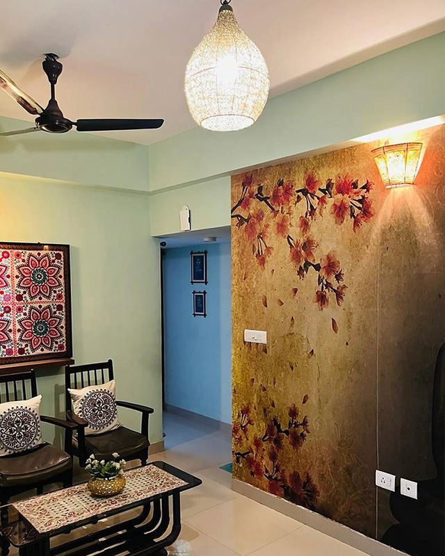 living-room-with-floral-wallpaper-and-lighting-featuring-a-ceiling-lamp-wall-sconce-and-traditional-furniture Living room with floral wallpaper and lighting, featuring a ceiling lamp, wall sconce, and traditional furniture