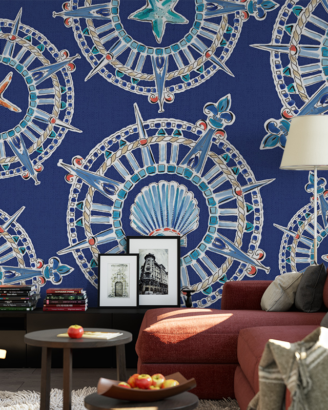 Living room with red sofa, framed photos, and intricate blue compass-themed wallpaper trends adding a nautical touch