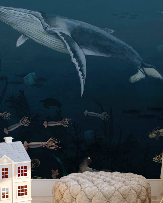 Room with underwater-themed blue wallpaper featuring a whale, squids, and sea turtles, along with a beige pouf and a toy house. Blue wallpaper trends