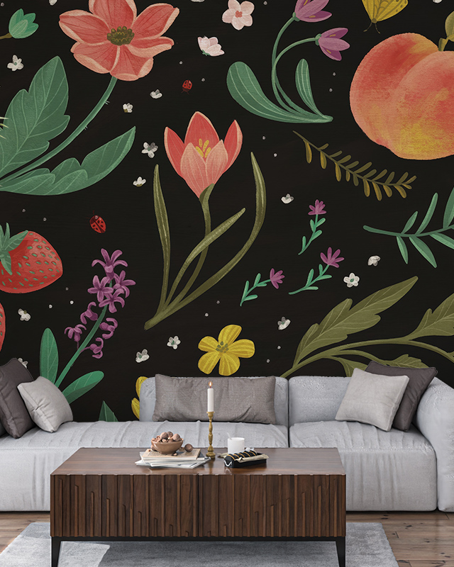 Floral Wallpaper Trend featuring colorful flowers, strawberries, and peaches on a black background. In front of the wallpaper is a sofa and wooden coffee table with a candle Floral Wallpaper Trend featuring colorful flowers, strawberries, and peaches on a black background. In front of the wallpaper is a sofa and wooden coffee table with a candle.