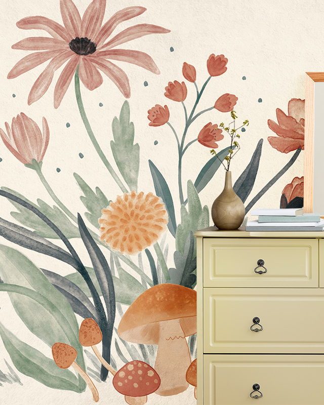 Floral Wallpaper Trend featuring soft pink flowers, green leaves, and mushrooms on a light background. In front of the wallpaper is a beige dresser with a vase and books on top. Floral Wallpaper Trend featuring soft pink flowers, green leaves, and mushrooms on a light background. In front of the wallpaper is a beige dresser with a vase and books on top.