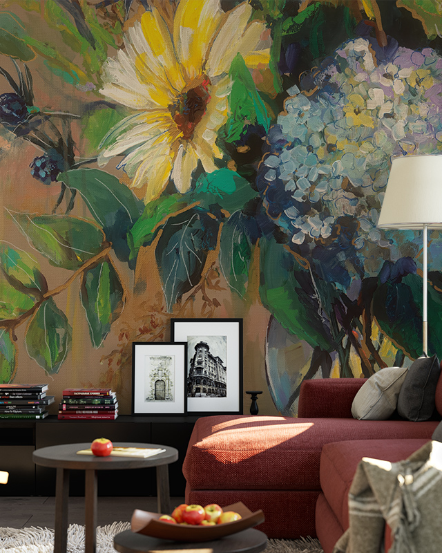 Floral Wallpaper vs Other Styles featuring a vibrant floral design with large leaves, yellow and blue flowers In front of the wallpaper, a red sofa, side table with framed photos.