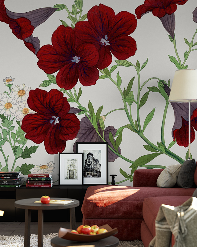 Floral Wallpaper vs Other Styles featuring large red flowers and green foliage In front of the wallpaper, a red sofa, a coffee table, framed pictures.
