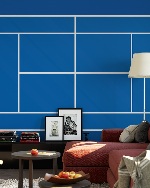 A cozy game room with tennis court-themed sports wallpaper for game rooms, a red sofa, and framed art.