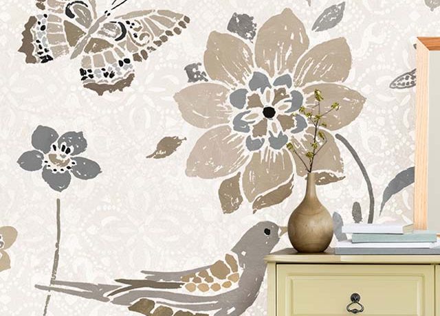 A dresser against beige wallpaper with floral, bird, and butterfly designs, ideal Beige Wallpaper for Commercial Spaces.