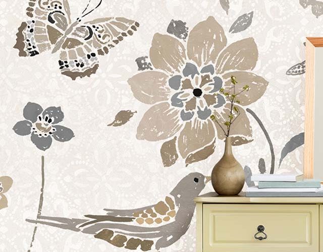 A dresser against beige wallpaper with floral, bird, and butterfly designs, ideal Beige Wallpaper for Commercial Spaces.