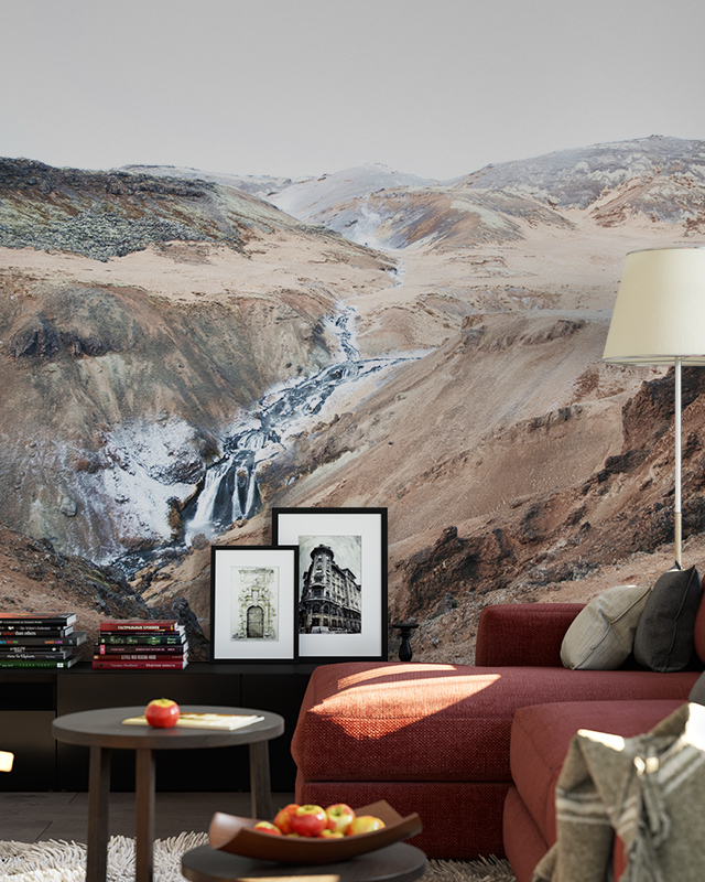 a-living-room-featuring-beige-wallpaper-for-commercial-spaces-with-a-scenic-mountain-landscape-a-red-sofa-framed-art-and-books-in-front A living room featuring Beige Wallpaper for Commercial Spaces with a scenic mountain landscape, a red sofa, framed art, and books in front.