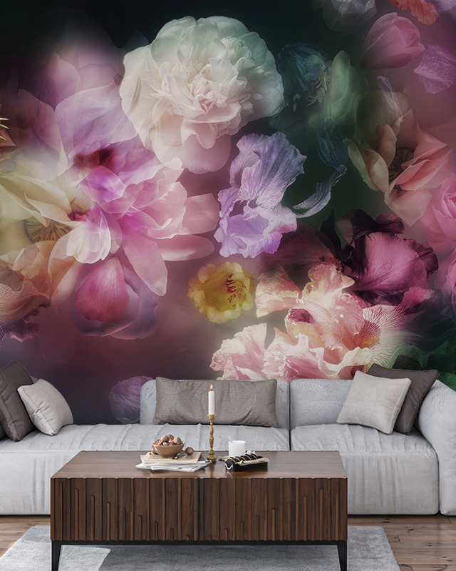A vibrant, abstract floral wallpaper with a blend of pink, purple, and white flowers. In front, there's a wooden table with a sofa with pillows, comparison of abstract wallpaper with other styles.