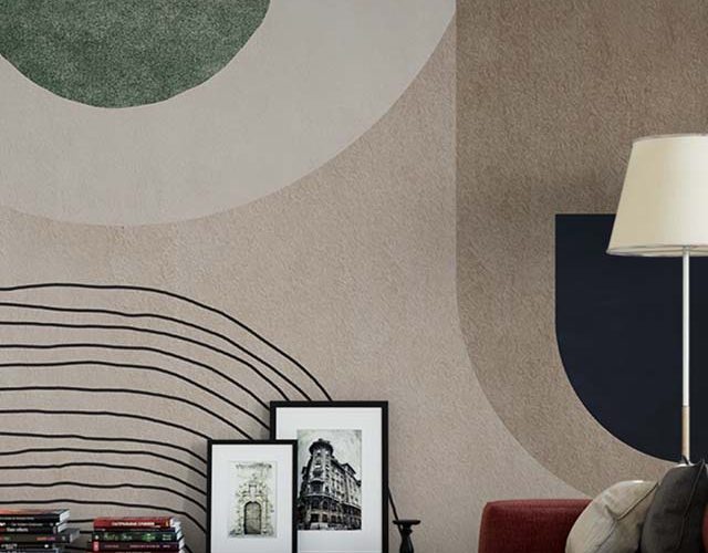 Abstract wallpaper with geometric shapes in green, beige, and black behind a modern sofa, ideal for Abstract Wallpaper for Commercial Spaces.