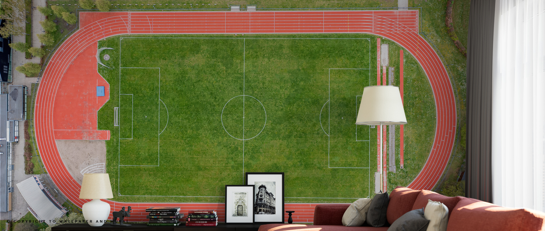 aerial-view-of-a-soccer-field-and-track-sports-wallpaper-trends-with-a-sofa-lamp-and-framed-art-in-the-foreground Aerial view of a soccer field and track sports wallpaper trends, with a sofa, lamp, and framed art in the foreground.