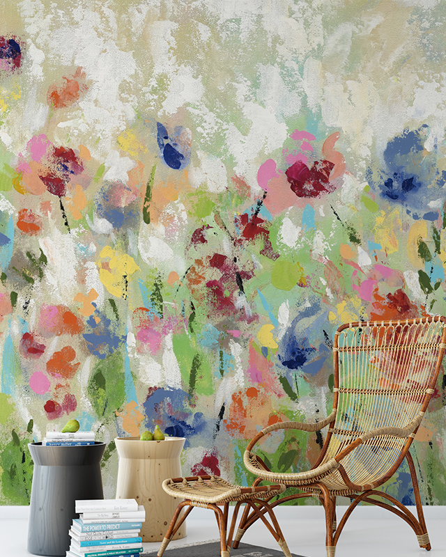 Colorful abstract floral wallpaper in the background with a wicker chair and side tables in front, demonstrating Comparison of Abstract Wallpaper with Other Styles