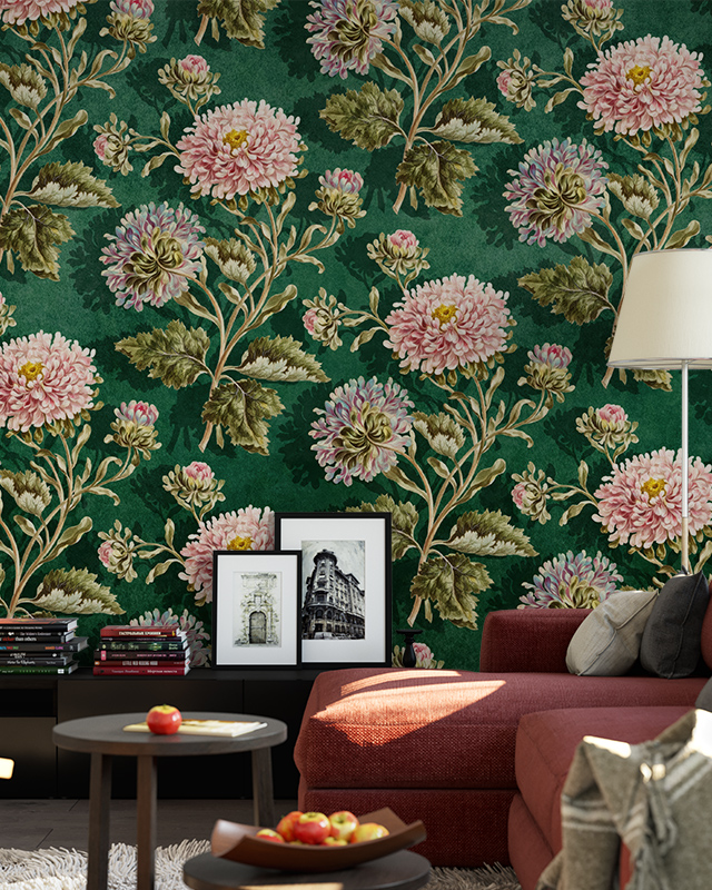 Floral wallpaper for different rooms with pink blooms, a red sofa, a side table, and framed artwork in front.