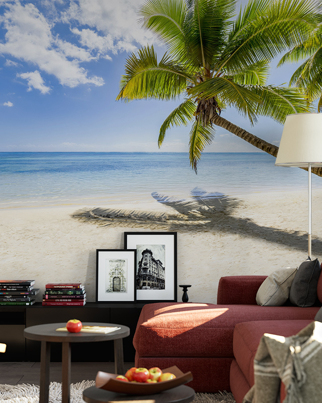 living room featuring a beach-themed mural wallpaper with palm trees, with a red sofa, coffee table, and framed pictures in front, for a comparison of abstract wallpaper with other styles.