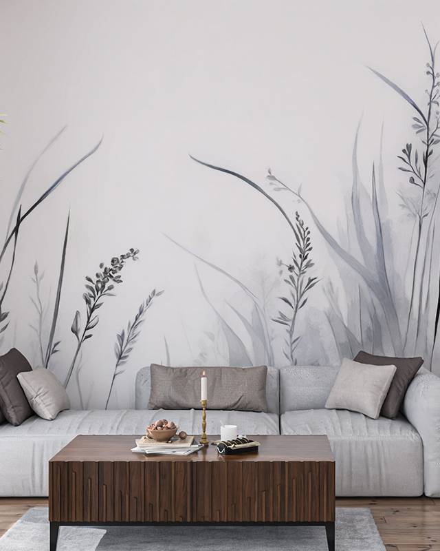 Monochromatic botanical wallpaper installation behind a modern sofa and wooden coffee table