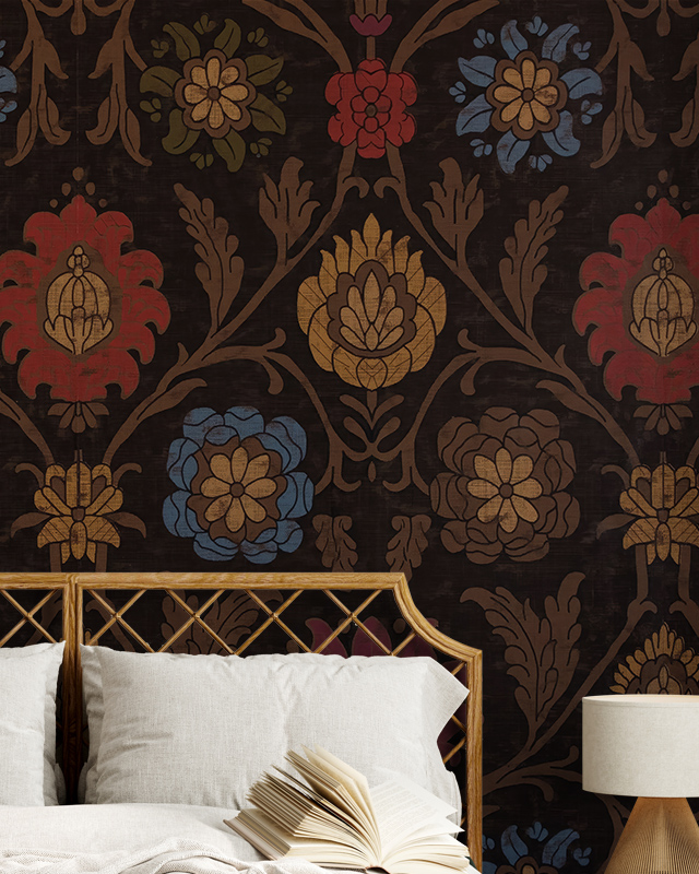 Ornate floral patterned wallpaper in dark tones with a rattan headboard, white pillows, an open book, and a lamp in front, illustrating Comparison of Abstract Wallpaper with Other Styles