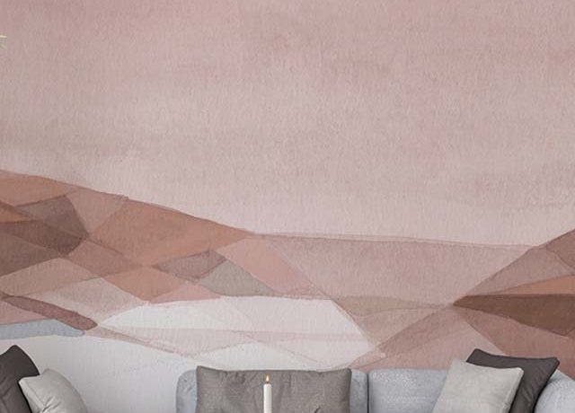 soft pink and beige abstract wallpaper with geometric shapes in front of a modern sofa highlighting comparison of abstract wallpaper with other styles