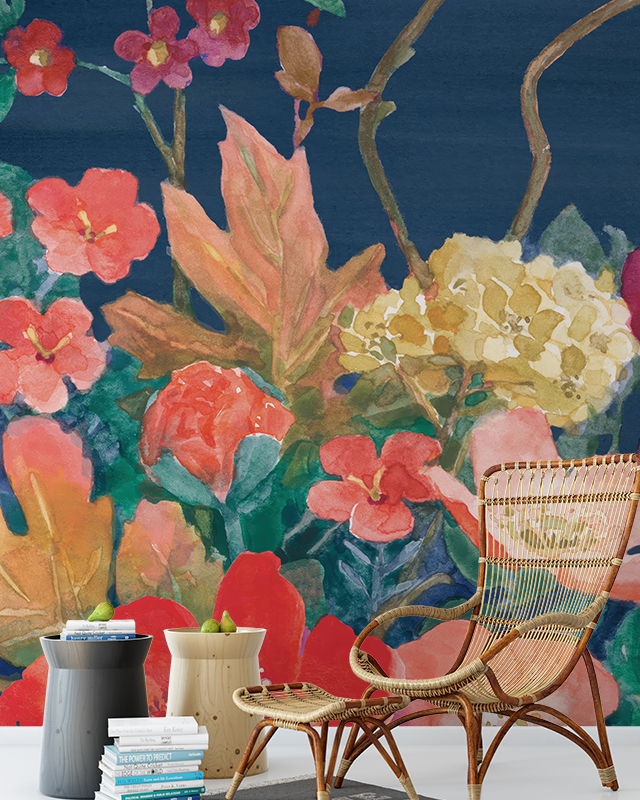 vibrant-floral-wallpaper-trend-featuring-bold-red-orange-and-yellow-flowers-against-a-dark-blue-background-the-room-includes-a-wicker-chair-two-side-tables-and-a-stack-of-books Vibrant floral wallpaper trend featuring bold red, orange, and yellow flowers against a dark blue background. The room includes a wicker chair, two side tables, and a stack of books.