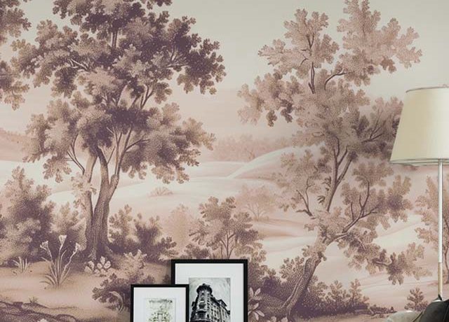 A living room with beige wallpaper showcasing a scenic tree landscape, paired with framed art and a red sofa. This highlights the Benefits of using Beige Wallpaper in Small Spaces.