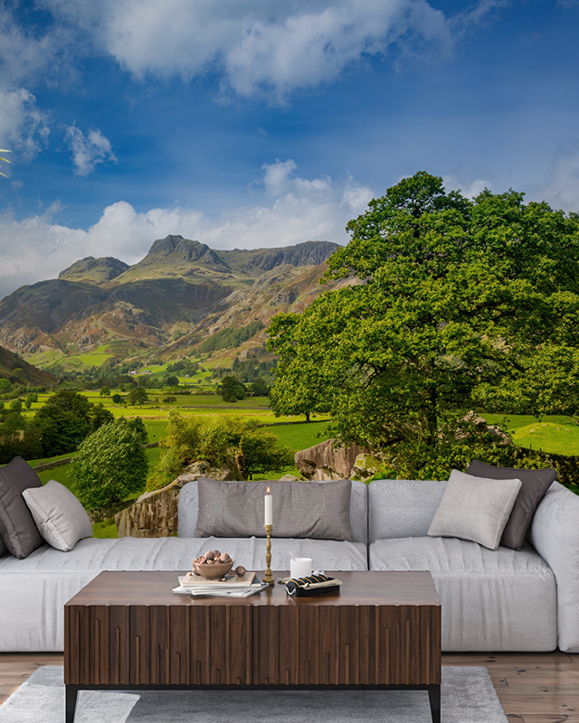 a-lush-mountain-landscape-mural-enhances-the-living-space-showcasing-wallpaper-for-different-workplaces-to-inspire-relaxation A lush mountain landscape mural enhances the living space, showcasing wallpaper for different workplaces to inspire relaxation.