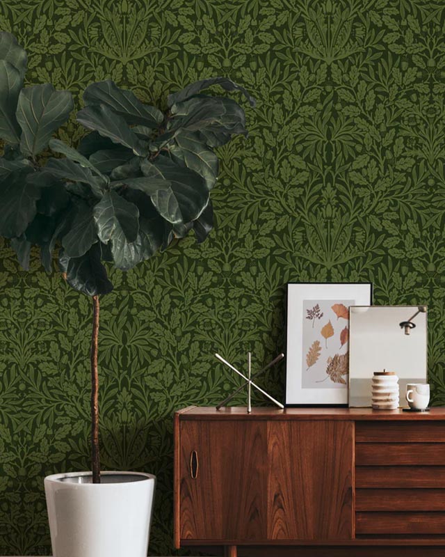 a-wooden-cabinet-and-large-plant-in-front-of-green-william-morris-wallpaper-vs-modern-wallpaper-styles A wooden cabinet and large plant in front of green William Morris wallpaper vs. Modern Wallpaper Styles.