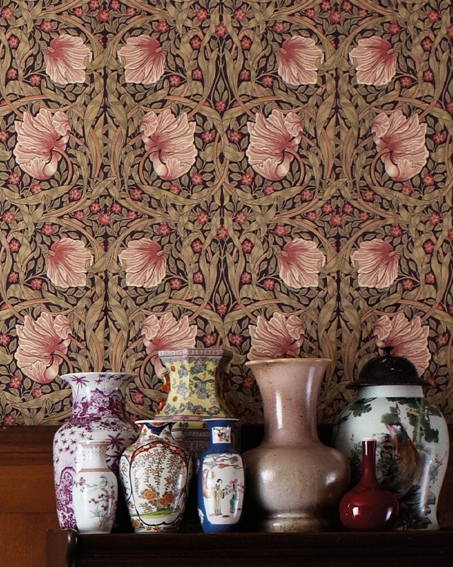 antique-vases-displayed-in-front-of-intricate-william-morris-wallpaper-vs-modern-wallpaper-styles-featuring-pink-floral-patterns Antique vases displayed in front of intricate William Morris wallpaper vs. Modern Wallpaper Styles featuring pink floral patterns.