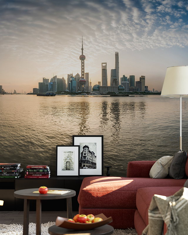 city-skyline-wallpaper-featuring-waterfront-view-at-sunset-behind-a-red-sofa-ideal-wallpaper-for-small-offices City skyline wallpaper featuring waterfront view at sunset behind a red sofa. Ideal wallpaper for small offices.
