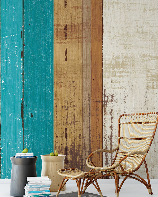 colorful-wooden-plank-peel-and-stick-wallpaper-trends-behind-a-wicker-chair-side-tables-and-stacked-books-in-a-cozy-setup Colorful wooden plank Peel and Stick Wallpaper trends behind a wicker chair, side tables, and stacked books in a cozy setup.