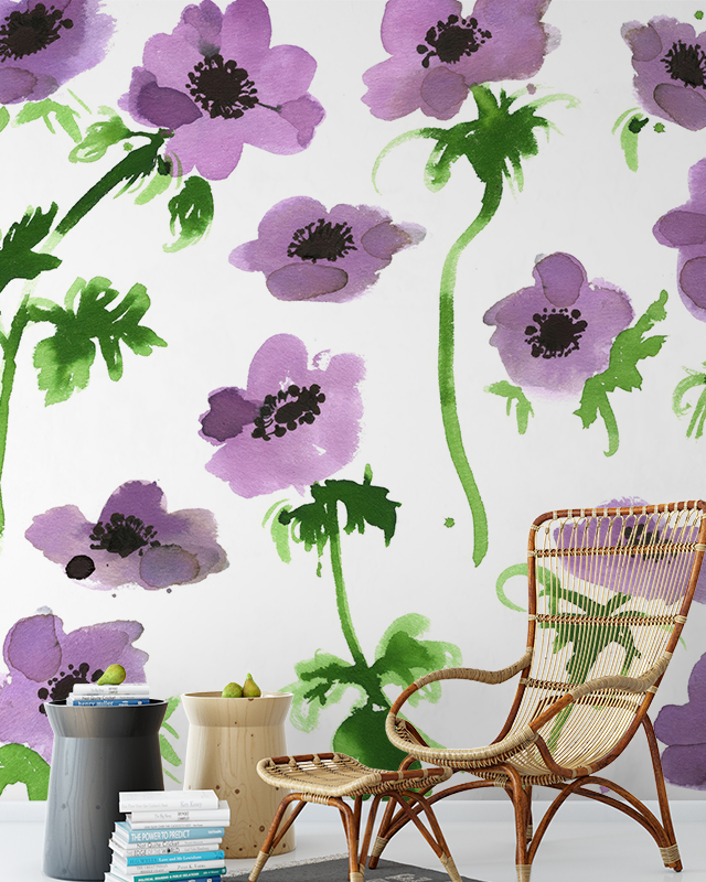 Designing Accent Walls with teens room wallpaper featuring large purple flowers, wicker chair, stacked books, and side tables.