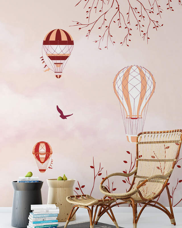 Hot air balloon-themed wallpaper with soft pink clouds and tree branches, perfect for designing accent walls with teens room wallpaper.