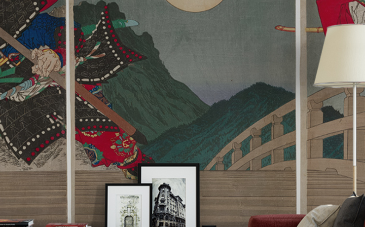 Japandi wallpaper with other styles featuring samurai art, framed pictures, red sofa, and modern decor accents.