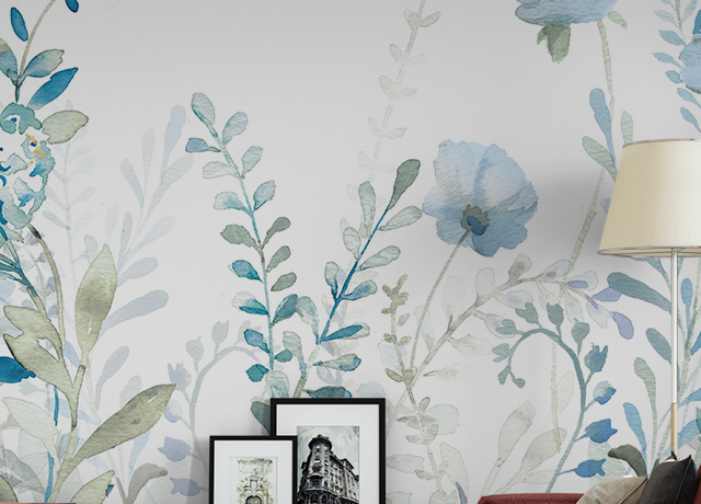 Removable wallpaper with blue floral design behind a red sofa and framed art pieces on a black console, showcasing remove removable wallpaper benefits.