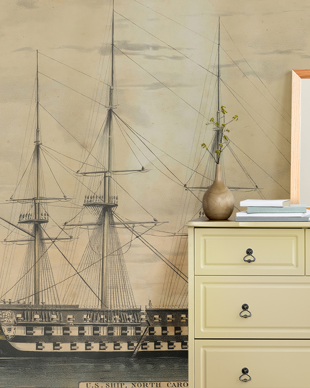 room-with-a-dresser-vase-and-books-in-front-of-benefits-of-using-beige-wallpaper-in-small-spaces-featuring-a-vintage-ship-illustration Room with a dresser, vase, and books in front of Benefits of using Beige Wallpaper in Small Spaces featuring a vintage ship illustration.