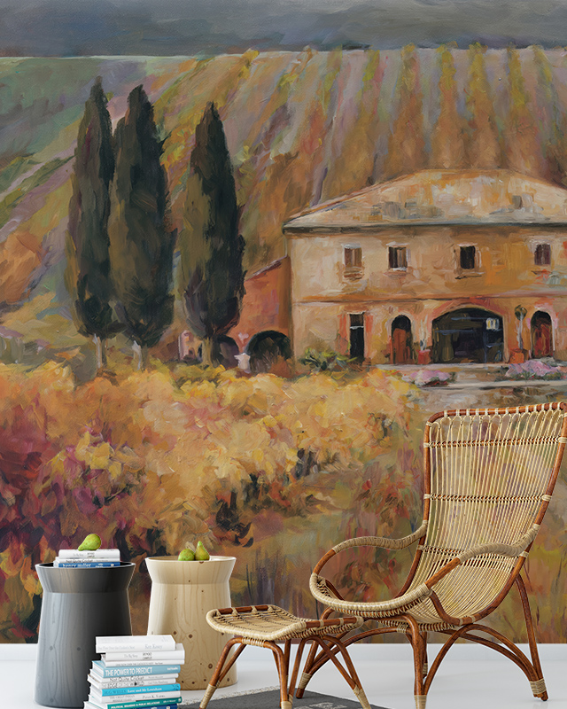 Vintage Wallpaper for Accent Walls featuring a rustic villa with cypress trees, wicker chair, and side tables in front.