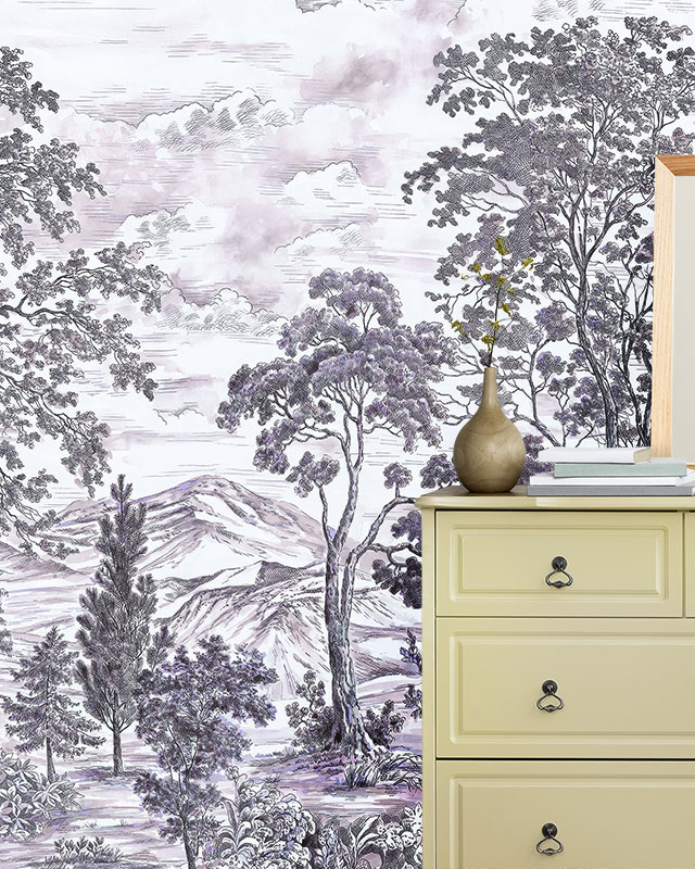 vintage-wallpapers-for-large-spaces-featuring-a-scenic-mountain-landscape-in-purple-tones-with-a-beige-dresser-in-front Vintage wallpapers for large spaces featuring a scenic mountain landscape in purple tones, with a beige dresser in front.