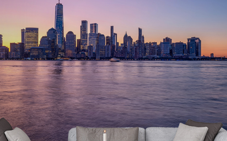 Wallpaper for open office layouts featuring a city skyline at sunset, with gray sofas and a wooden coffee table.
