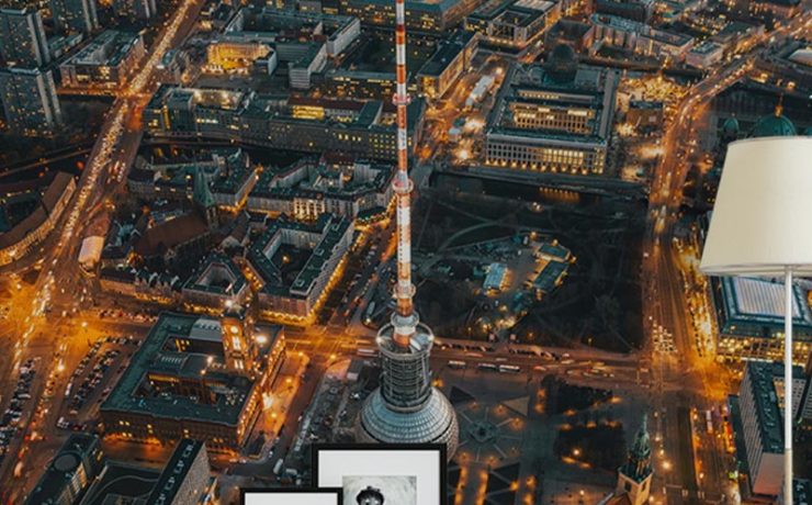 Aerial view of a cityscape at night, featuring framed pictures and a lamp in front, showcasing Types of Urban Wallpaper.