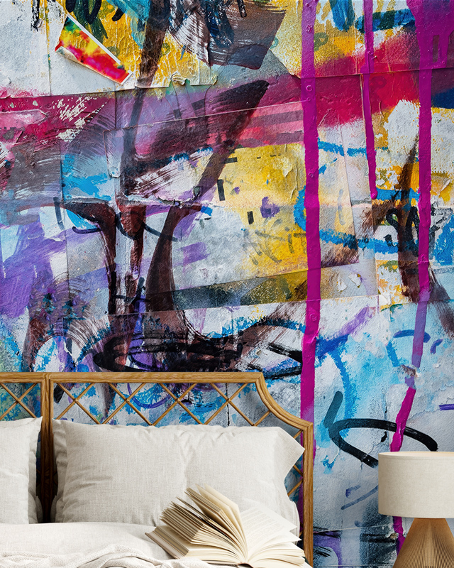 Bedroom with an abstract, graffiti-style mural featuring bold colors and brushstrokes, showcasing types of urban wallpaper designs.