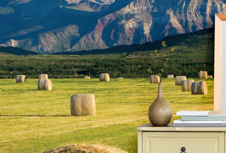 Bedroom with nature-themed mural featuring hay bales and mountains, offering room-by-room bright wallpaper ideas for decor.