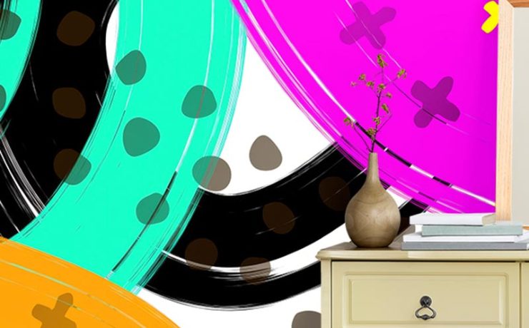 Beige dresser in front of bright wallpaper for different design styles, featuring bold abstract swirls and shapes.