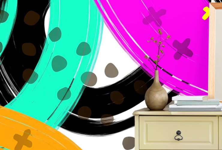 Beige dresser in front of bright wallpaper for different design styles, featuring bold abstract swirls and shapes.