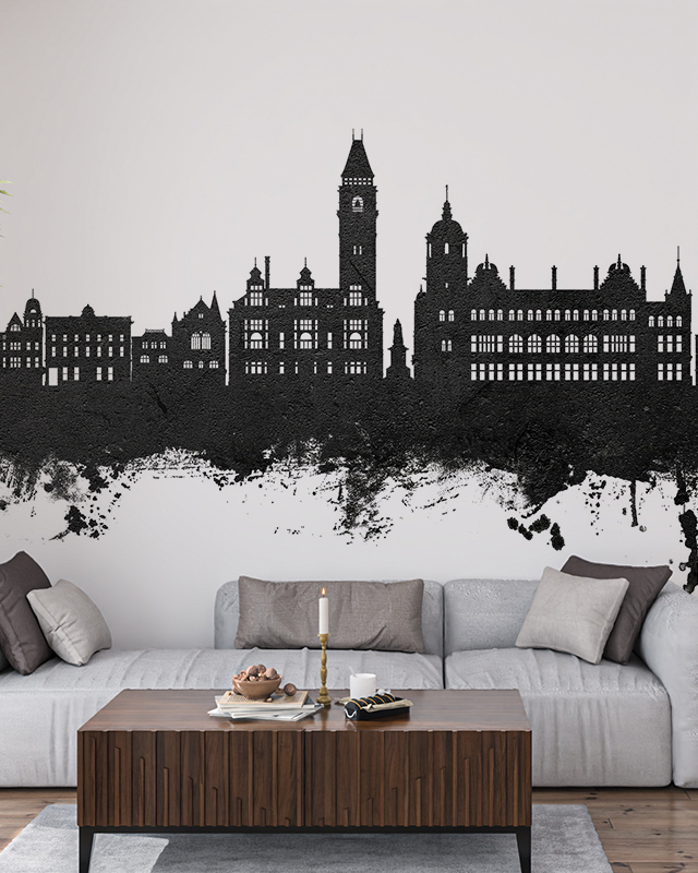 Black city skyline mural on a white wall in a modern living room, featuring urban wallpaper for commercial spaces.