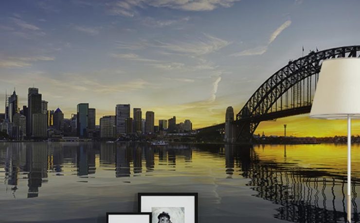 City skyline and bridge mural at sunset in a cozy living room, showcasing Urban Wallpaper for Small Spaces.