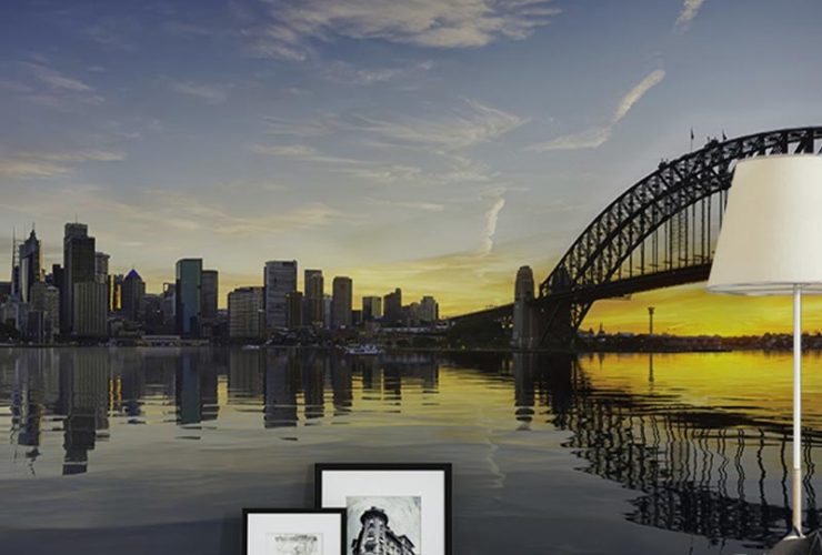 City skyline and bridge mural at sunset in a cozy living room, showcasing Urban Wallpaper for Small Spaces.