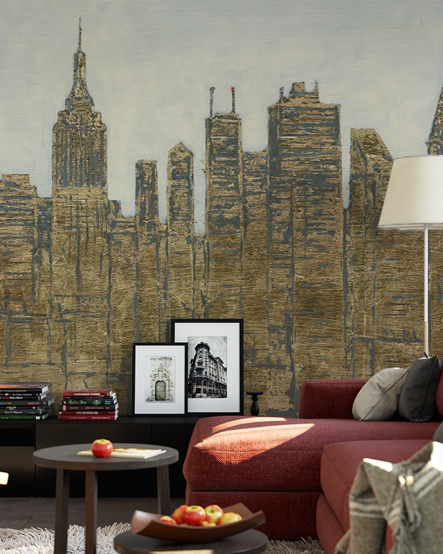 Living room with a textured mural of a city skyline in muted gold tones, showcasing types of urban wallpaper designs.