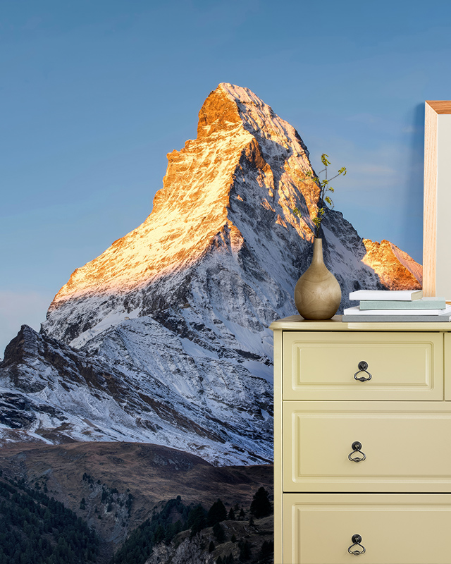 Mountain peak wallpaper with snow-capped summit in a bedroom, illustrating room-by-room bright wallpaper ideas.