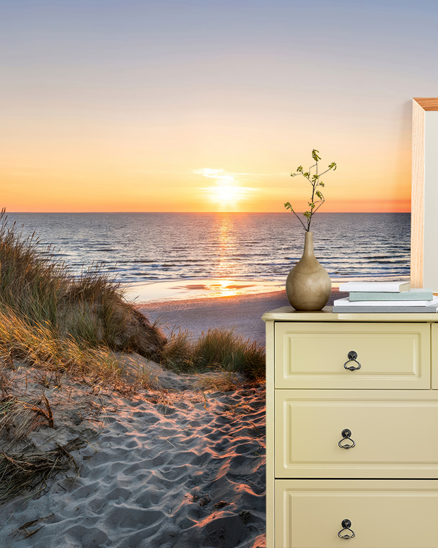 Sunset beach scene wallpaper with sandy dunes in a bedroom, showcasing room-by-room bright wallpaper ideas.
